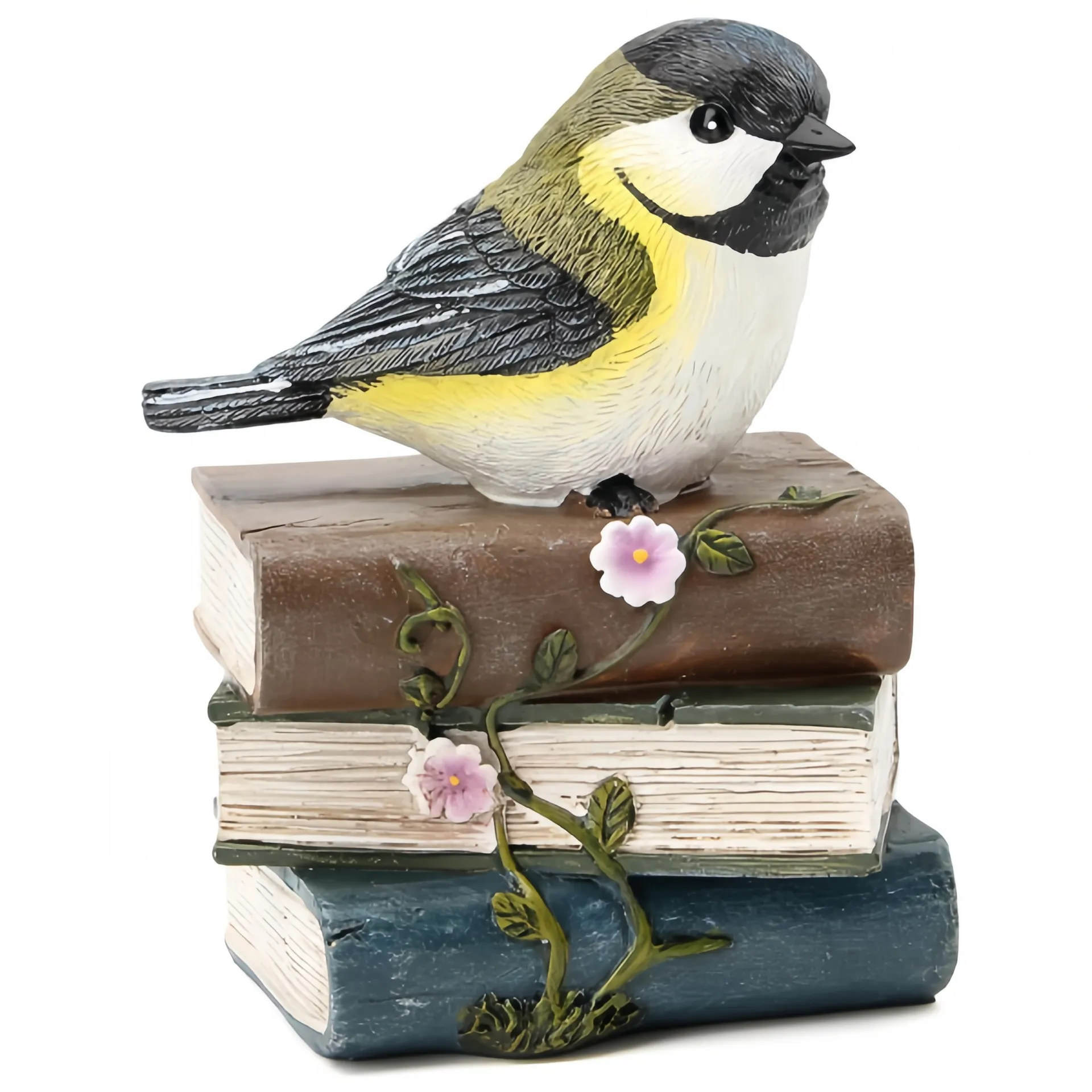 Eine dekorative Figur eines Vogels, der auf einem Stapel von drei Büchern sitzt und mit rosa Blumen und grünen Ranken geschmückt ist.