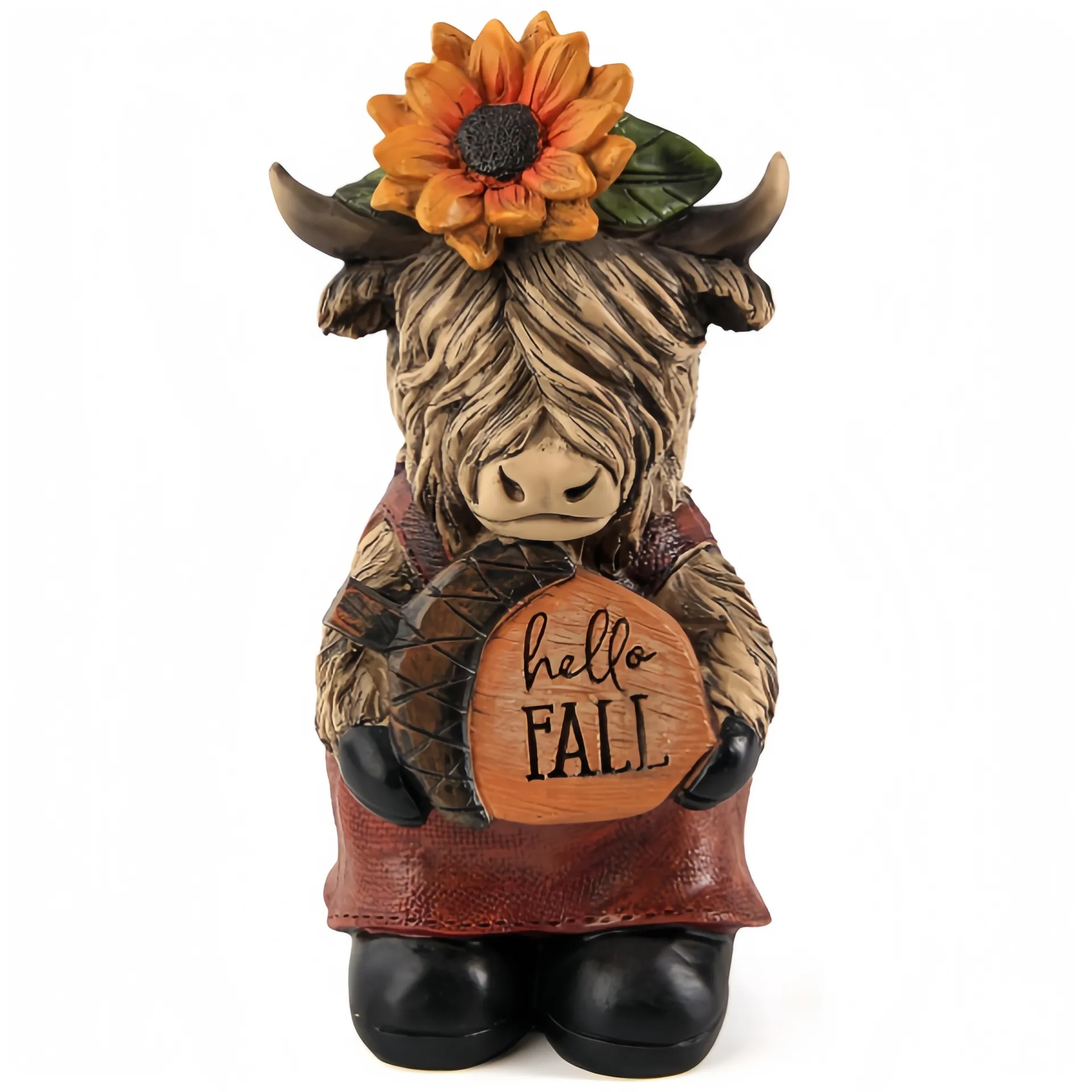 Eine dekorative Figur einer Hochlandkuh, die eine Sonnenblume trägt und ein Schild mit der Aufschrift 'Hello Fall.&#039 hält;