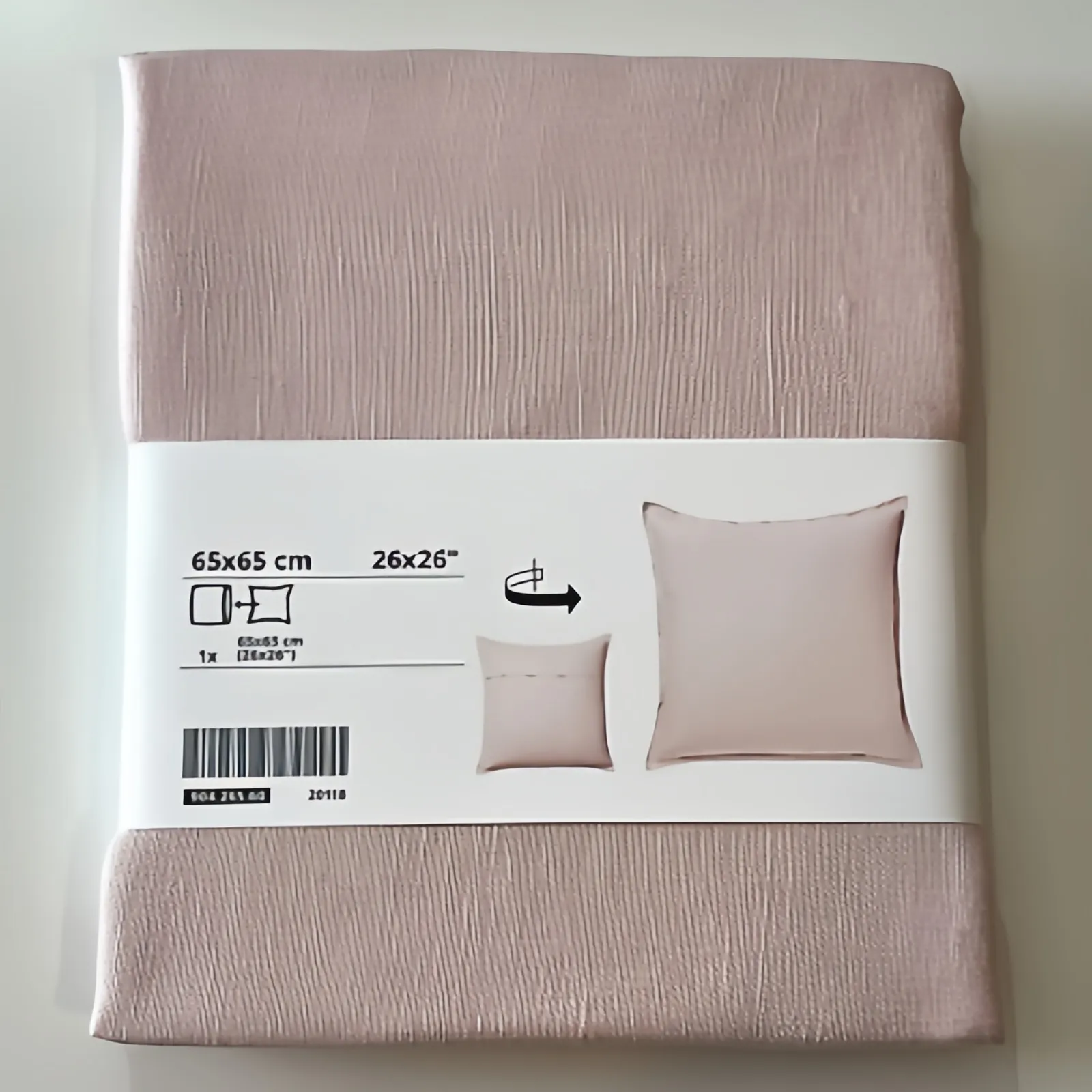A package of a 65x65 cm beige pillowcase with printed label showing product information.