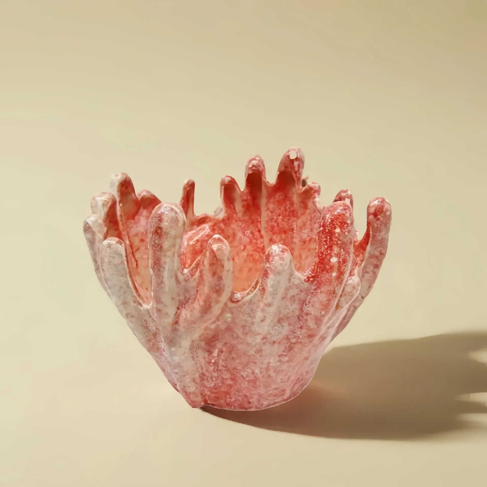 A coral-shaped ceramic bowl with pink and white textures.