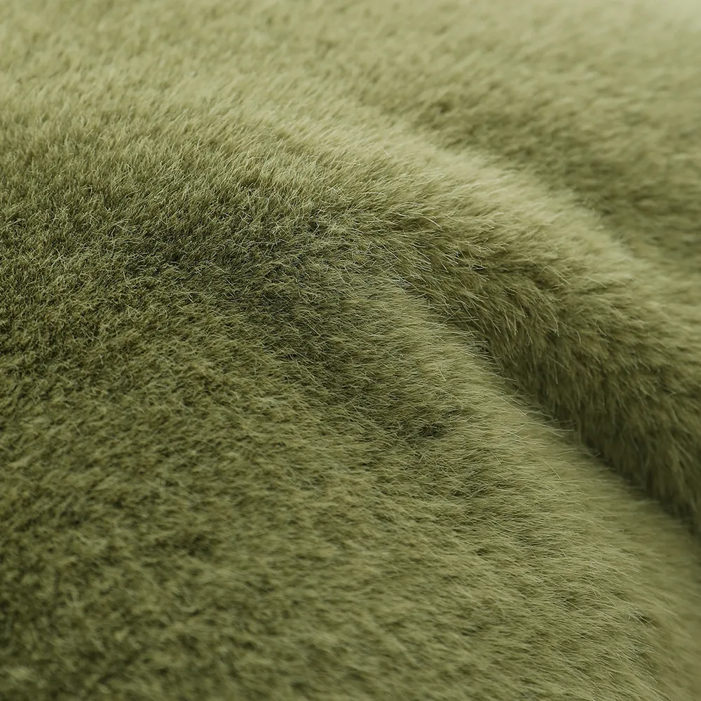 A close-up of soft, fuzzy green fabric texture.