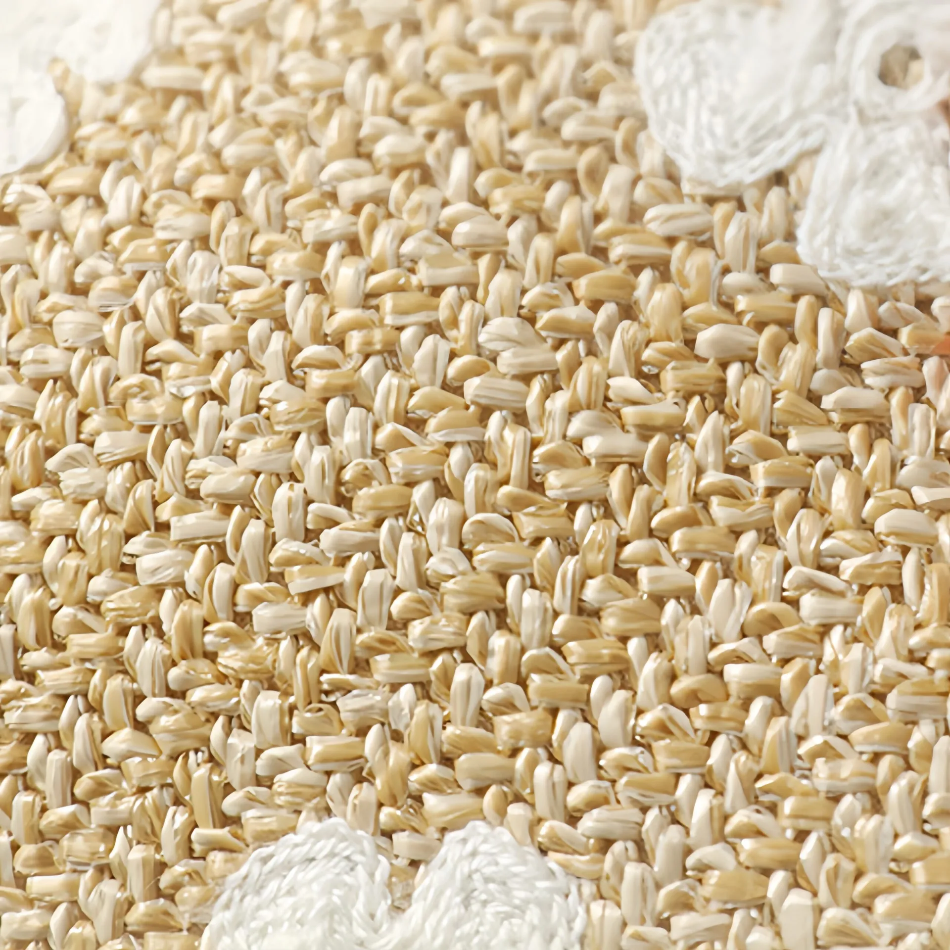 Close-up view of a woven straw texture with a detailed pattern.
