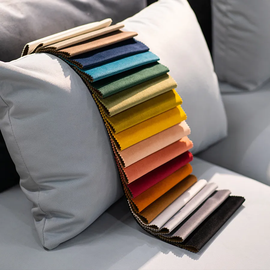 A variety of velvet fabric swatches in different colors displayed on a cushion.