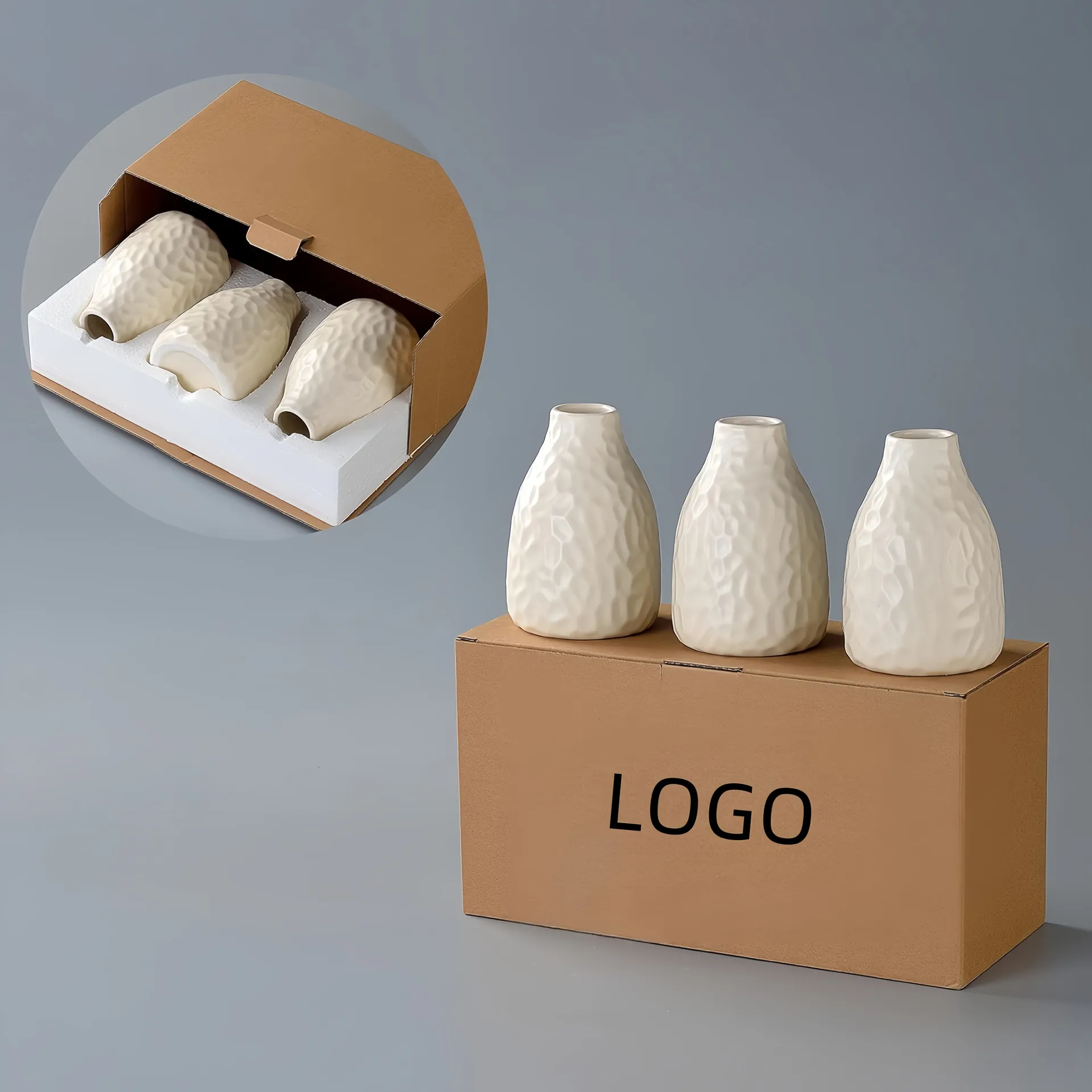 Three ceramic vases placed on a cardboard box with their packaging open showing how they are packed.