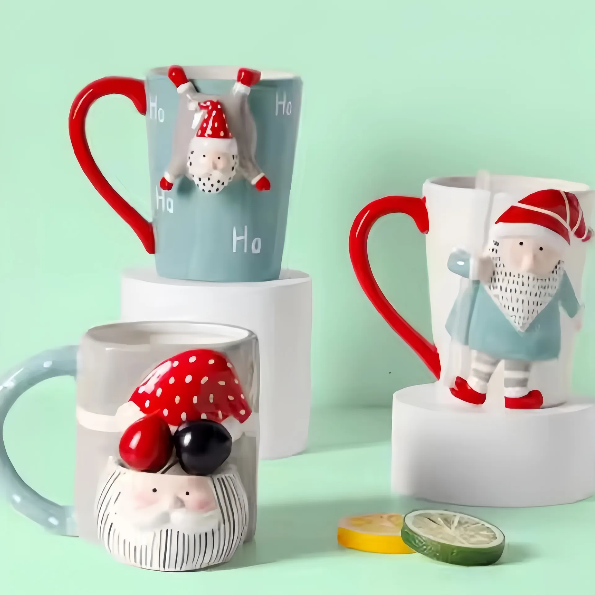 Three whimsical Santa-themed mugs with red handles and 3D Santa Claus figures.