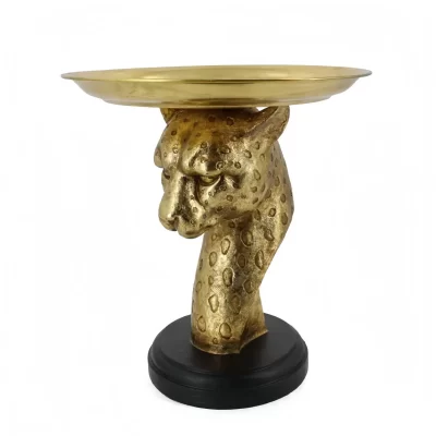 Ein dekorativer Tisch mit einem goldenen Leopardenkopf als Sockel und einer runden, flachen Oberfläche, die auf einem schwarzen Sockel steht.
